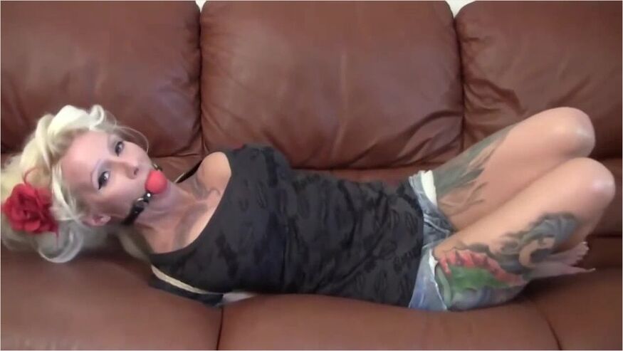 Tattooed Girl Tied Up On The Sofa